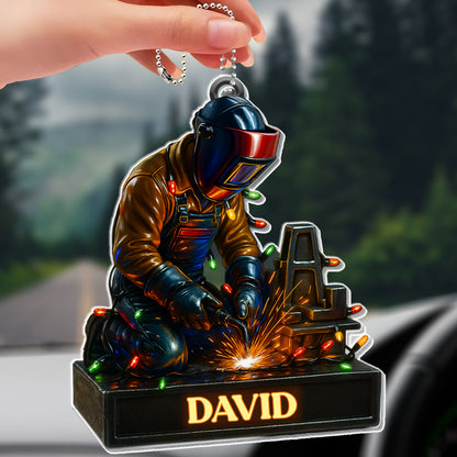 Skilled Welder At Work With Festive Lights