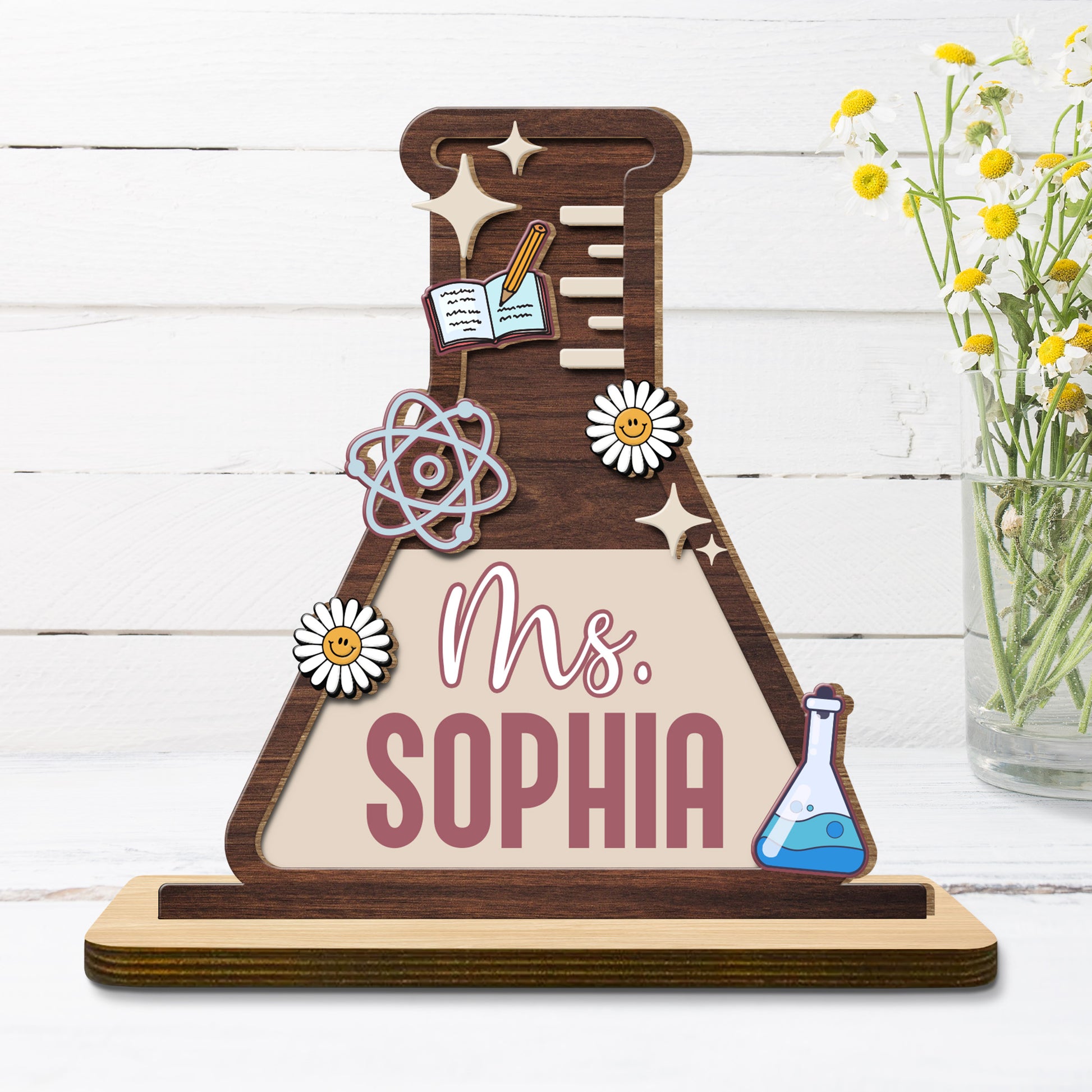 Celebrate Knowledge With Daisies, Atom Model, Notebook, and Beaker